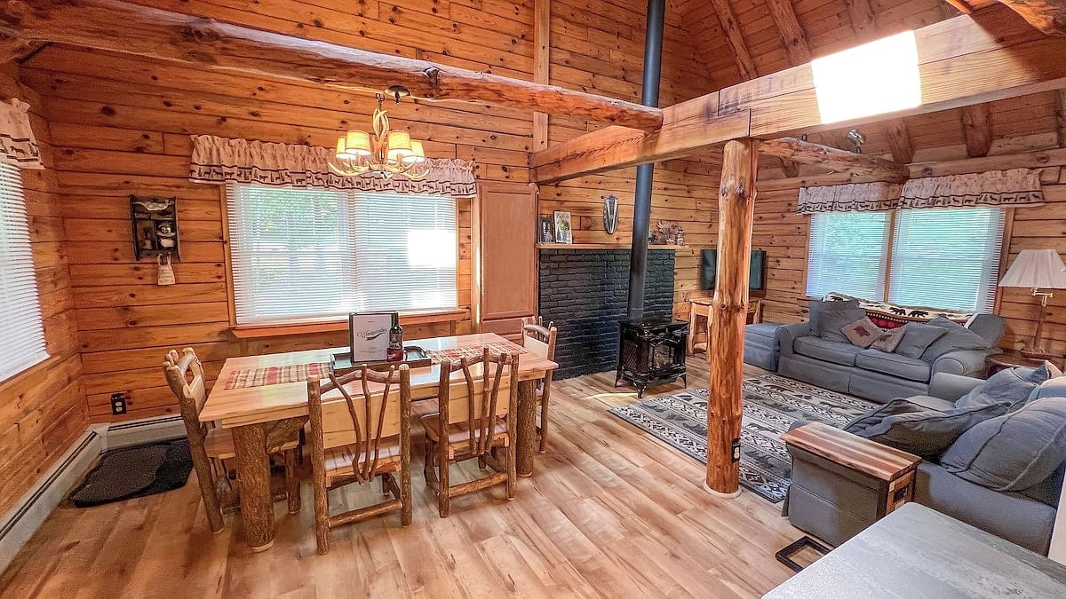 Open-concept log cabin living and dining room